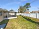 View of the backyard with a screened lanai and a white privacy fence at 4057 Amron Dr, Orlando, FL 32822