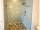 Modern bathroom with tiled shower and pebble flooring at 4057 Amron Dr, Orlando, FL 32822