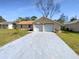 Charming single-story home with a brick facade and an attached two-car garage at 4057 Amron Dr, Orlando, FL 32822