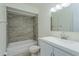 Bathroom with white tiled shower over bathtub and vanity with sink at 414 Tranquille Oaks Dr, Ocoee, FL 34761