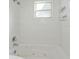 Close up of white tiled bathtub and shower at 414 Tranquille Oaks Dr, Ocoee, FL 34761