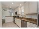 A bright kitchen featuring stainless steel appliances, granite countertops, and modern cabinetry at 414 Tranquille Oaks Dr, Ocoee, FL 34761