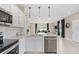 Kitchen with stainless steel appliances flowing into an open-concept living and dining area at 415 Meadowland Pt, Oviedo, FL 32765