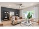 Comfortable living room featuring a cozy sofa and decorative shelving at 423 Meadowland Pt, Oviedo, FL 32765