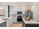 Well-lit kitchen with stainless steel appliances, white cabinets, and a center island with a marble countertop at 431 Meadowland Pt, Oviedo, FL 32765