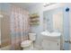 Cozy bathroom featuring a white sink, toilet, and decorative shower curtain at 4523 Saddle Creek Pl, Orlando, FL 32829