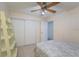 A simple bedroom featuring a queen-sized bed and a closet with sliding doors for easy storage at 4523 Saddle Creek Pl, Orlando, FL 32829