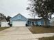 Charming single-Gathering home with a well-maintained lawn, white garage door and complementing light blue paint at 4523 Saddle Creek Pl, Orlando, FL 32829