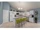 Bright kitchen with white cabinets, a center island with seating, and a stainless-steel dishwasher at 4523 Saddle Creek Pl, Orlando, FL 32829