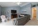 Cozy living room with vaulted ceilings, a fireplace, and a comfortable gray sofa at 4523 Saddle Creek Pl, Orlando, FL 32829