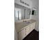 Bathroom featuring a white sink, a large vanity mirror, and wood floors at 516 Orange Dr # 17, Altamonte Springs, FL 32701