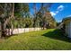 A large back yard enclosed by a wooden fence and features well-maintained grass and mature trees at 533 Little Wekiva Rd, Altamonte Springs, FL 32714