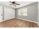 Bedroom featuring hardwood floors, a ceiling fan, closet and a window for natural light at 533 Little Wekiva Rd, Altamonte Springs, FL 32714