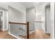 Hallway with wood floors, wooden banister and stairs leading to the next level at 533 Little Wekiva Rd, Altamonte Springs, FL 32714