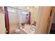 Cozy bathroom featuring a tub and shower combo, single sink vanity, and tiled walls at 5436 Bayberry Homes Rd, Orlando, FL 32811