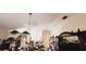 Dining room featuring chandelier, table and chairs, and a large ornamental hutch at 5436 Bayberry Homes Rd, Orlando, FL 32811