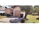 Front view of a single-story home with garage, driveway and small front yard at 5436 Bayberry Homes Rd, Orlando, FL 32811