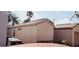 View of the side of the home showing beige stucco and light brown trim and the roof at 5436 Bayberry Homes Rd, Orlando, FL 32811