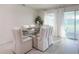 Elegant dining area with a glass table, stylish chairs, and sliding glass doors at 560 Newton Rd, Port Orange, FL 32127