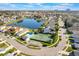 A high-angle shot showing neighborhood amenities, tennis courts, a swimming pool, and picturesque landscaping at 5795 Parkview Lake Dr, Orlando, FL 32821