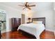 Bedroom with wood floors, ceiling fan, and dark wood furniture at 5795 Parkview Lake Dr, Orlando, FL 32821