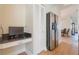 Hallway with a built-in desk and a stainless steel refrigerator at 5795 Parkview Lake Dr, Orlando, FL 32821