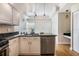 Modern kitchen with white cabinetry, stainless appliances and countertop seating at 5795 Parkview Lake Dr, Orlando, FL 32821