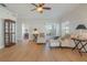 Light-filled living room with wood flooring, ceiling fan, and crown moulding at 5795 Parkview Lake Dr, Orlando, FL 32821