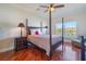 Main bedroom with dark wood furniture, a ceiling fan and a water view at 5795 Parkview Lake Dr, Orlando, FL 32821