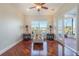 Inviting sun room featuring comfortable seating, wood floors and a peaceful view of the water at 5795 Parkview Lake Dr, Orlando, FL 32821