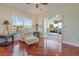 Inviting sun room featuring comfortable seating, wood floors and a peaceful outdoor view at 5795 Parkview Lake Dr, Orlando, FL 32821