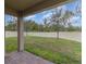 A covered patio and lush green grass highlight this fenced backyard, creating a perfect outdoor retreat at 6097 Monterey Cypress Trl, Sanford, FL 32773