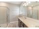 Stylish bathroom with a walk-in shower, vanity, and a large mirror at 6097 Monterey Cypress Trl, Sanford, FL 32773