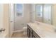 Well-lit bathroom featuring a double sink vanity, a large mirror, and wood look flooring at 6097 Monterey Cypress Trl, Sanford, FL 32773