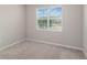 Comfortable bedroom with neutral carpet, a window, and fresh paint at 6097 Monterey Cypress Trl, Sanford, FL 32773