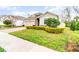 Inviting single-Gathering home with lush landscaping, stone accents and a brick driveway at 6097 Monterey Cypress Trl, Sanford, FL 32773