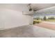 Bright, clean garage space featuring automatic door, white walls, and an attractive exterior view at 6097 Monterey Cypress Trl, Sanford, FL 32773