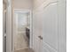 Hallway leading to a well-lit bathroom with modern fixtures at 6097 Monterey Cypress Trl, Sanford, FL 32773