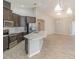 Modern kitchen with stainless steel appliances, tile backsplash, and white quartz countertop island at 6097 Monterey Cypress Trl, Sanford, FL 32773