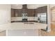 Well-lit kitchen featuring stainless steel appliances, quartz countertops, and tile backsplash at 6097 Monterey Cypress Trl, Sanford, FL 32773