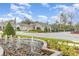 Charming community entrance with a water fountain, manicured landscaping, and well-maintained homes in the background at 6097 Monterey Cypress Trl, Sanford, FL 32773