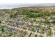 Aerial view of a neighborhood with tree lined street near water at 636 Bainbridge Loop, Winter Garden, FL 34787