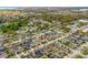 Aerial view of a residential neighborhood, highlighting tree-lined streets, well-maintained lawns, and houses at 636 Bainbridge Loop, Winter Garden, FL 34787