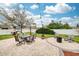 Landscaped backyard offers seating, fire pit, dining and play area, perfect for enjoying the outdoors at 636 Bainbridge Loop, Winter Garden, FL 34787