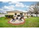 Spacious backyard with patio, fire pit, and play area, ideal for outdoor activities and gatherings at 636 Bainbridge Loop, Winter Garden, FL 34787