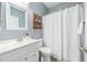 Bathroom with white vanity, modern faucet, and wooden shelving, offering a clean design at 636 Bainbridge Loop, Winter Garden, FL 34787