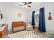 Charming bedroom with a crib, ceiling fan, and window, creating a cozy and inviting space at 636 Bainbridge Loop, Winter Garden, FL 34787