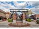 A vibrant Centennial Plaza entrance featuring flowers, seating, and nearby shops at 636 Bainbridge Loop, Winter Garden, FL 34787