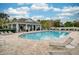 Inviting community pool area featuring lounge chairs, a covered pavilion, and manicured landscaping at 636 Bainbridge Loop, Winter Garden, FL 34787