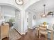 Open-concept dining area featuring wood floors and arched entryways to other rooms at 636 Bainbridge Loop, Winter Garden, FL 34787